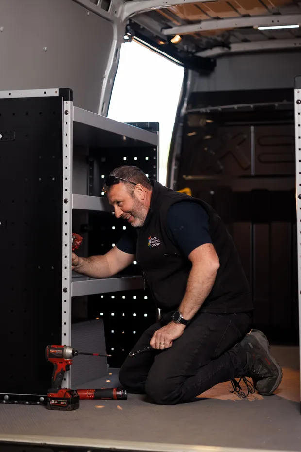 Modular racking being installed in a panel van