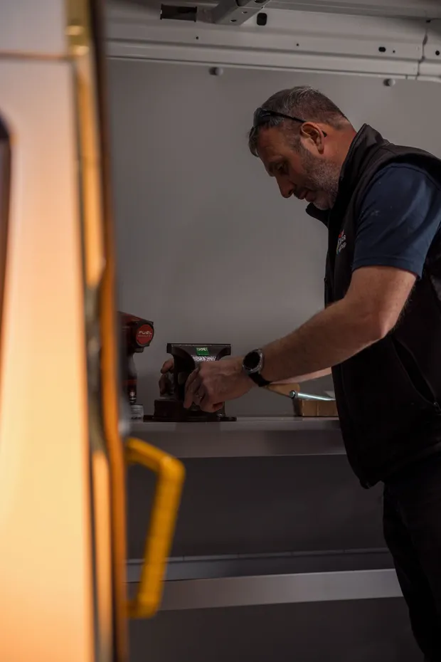 Conversion technician fitting out a van interior