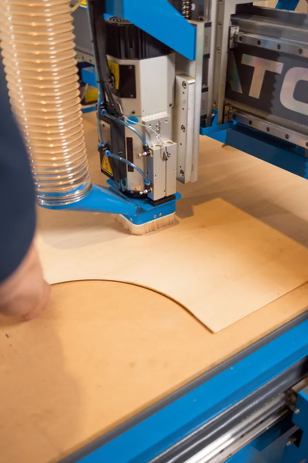 CNC router cutting a curved conversion panel