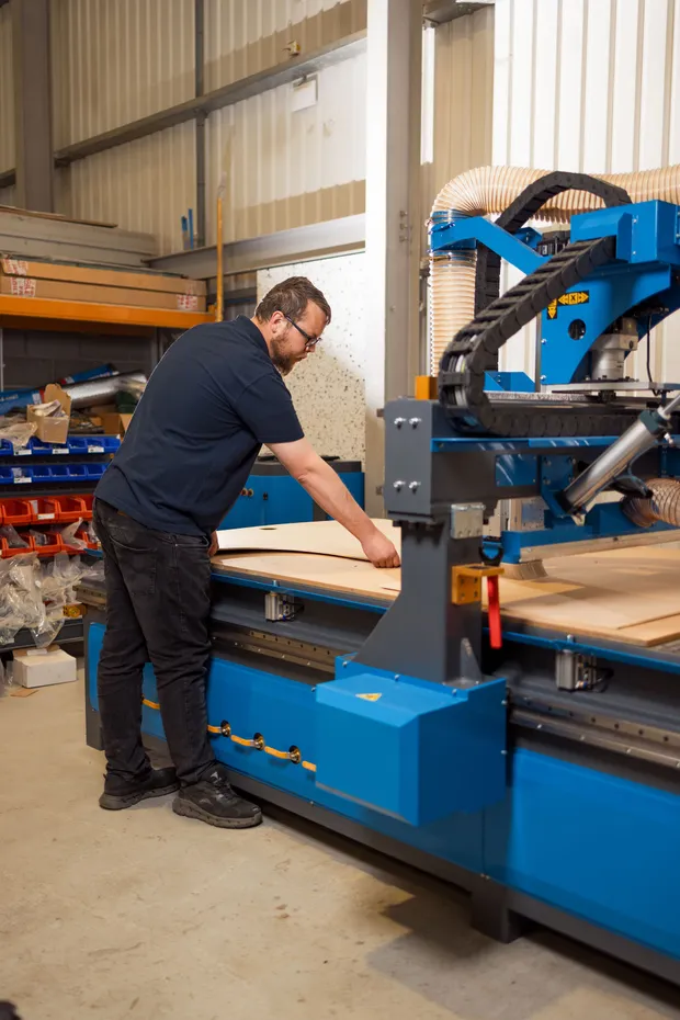 Dack technician preparing panels on the CNC router