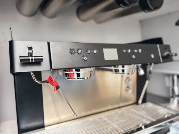 Twin-group commercial espresso machine fitted in the Cafe2U van