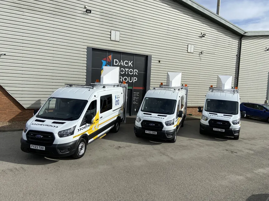 Three Chevron EMCC vans outside the Dack Motor Group conversion centre