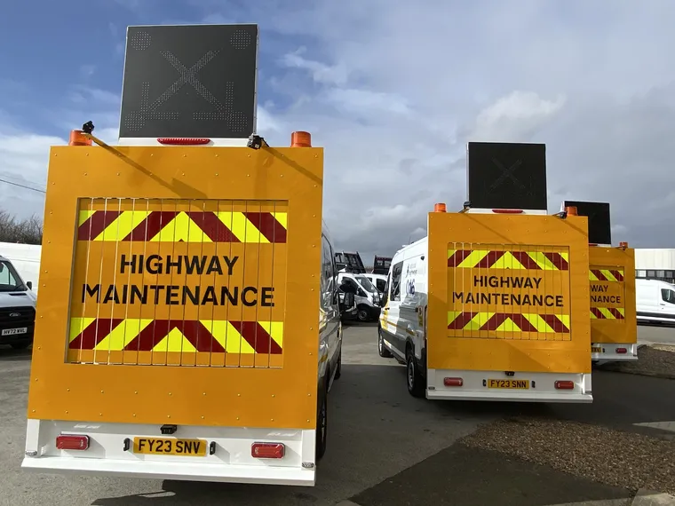 Rear of Chevron EMCC vans showing Highway Maintenance boards and roof-mounted lane closure signage